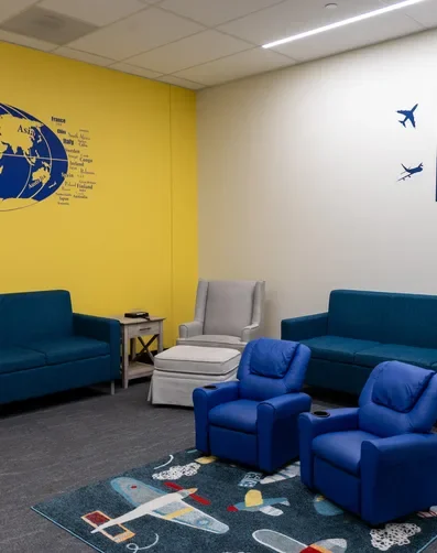 USO Family Room with murals, children's seating, and aviation decoration