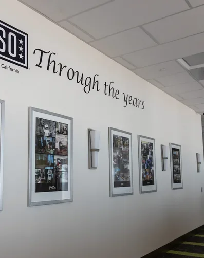USO Center gallery wall with service member photos on display