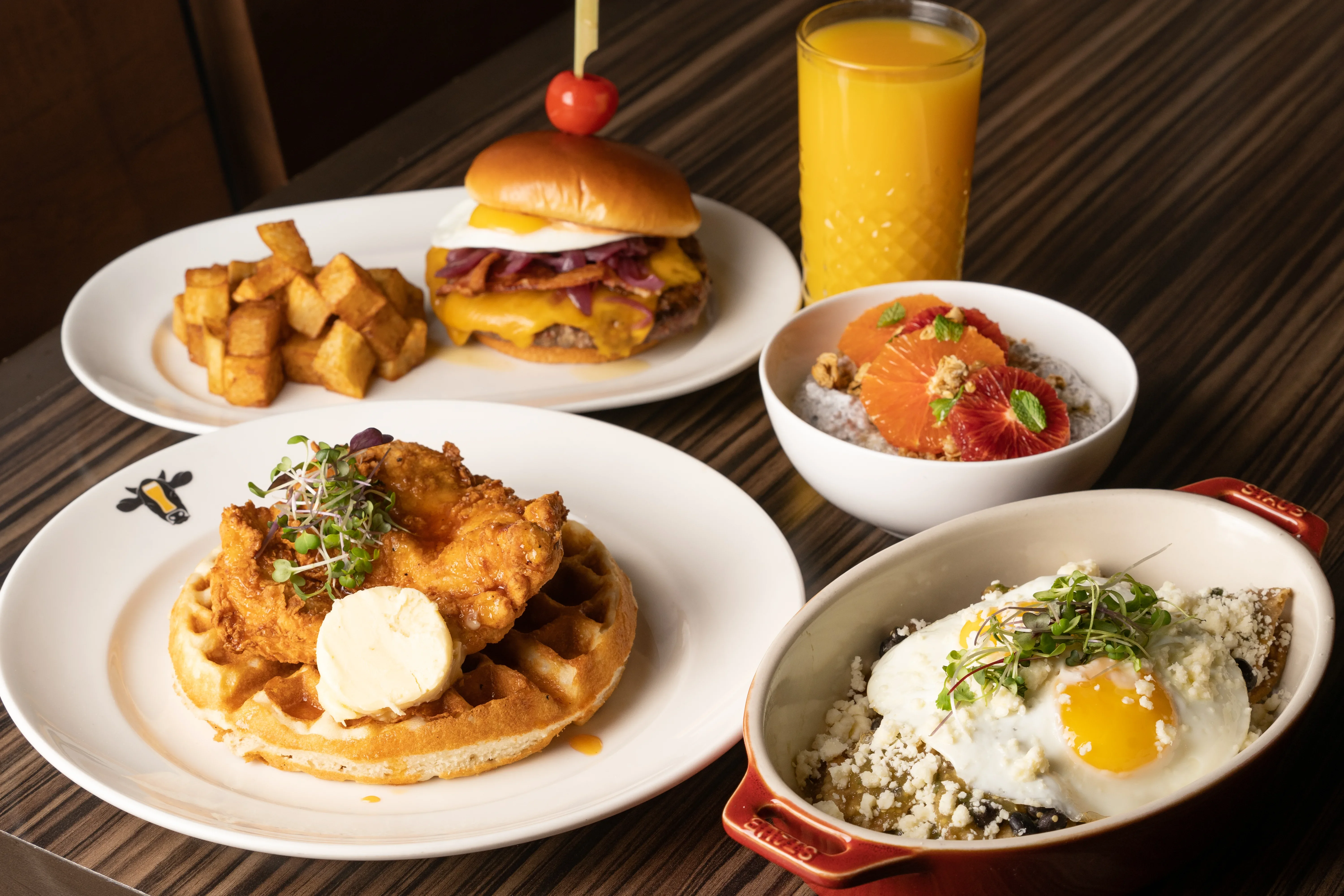 Bourbon Pub breakfast entrees like waffles, breakfast burgers, and chilaquiles with fried egg
