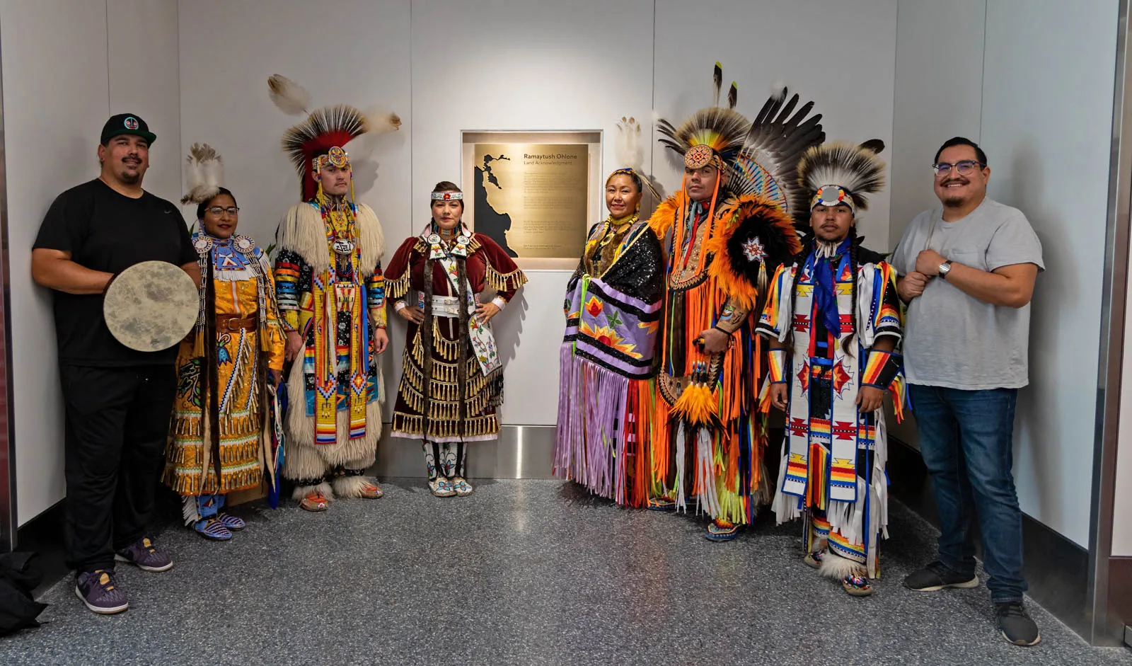 Members of the Association of Ramaytush Ohlone stand by the Land Acknowledgement plaque at SFO