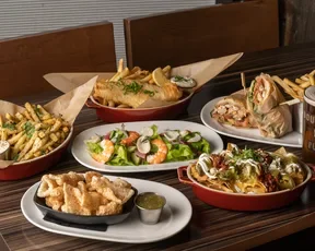 Bourbon Pub lunch items such as fries, wraps, and salads